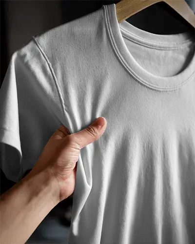 Hand Holding Tshirt Mockup Closeup Of White Tee With Design Space In Soft Light