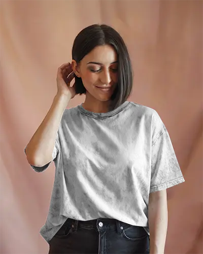 Acid Wash T Shirt Mockup Female Model Touching Hair Soft Smile On Rosy Backdrop Relaxed And Casual Styling