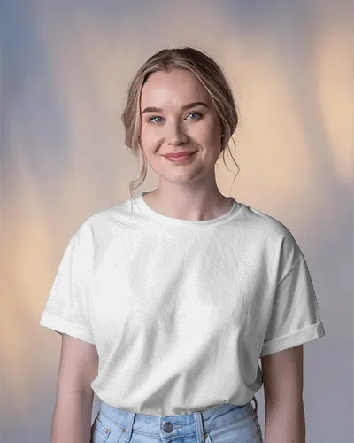 Smiling Woman Presenting T Shirt Against Soft Focus Background