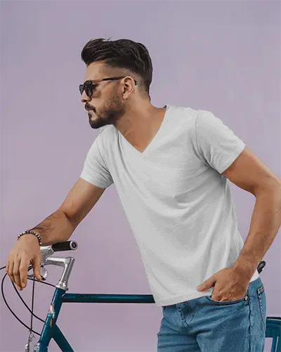 Laidback Tshirt Mockup With Handsome Man Resting On Bicycle In Soft Toned Studio Environment