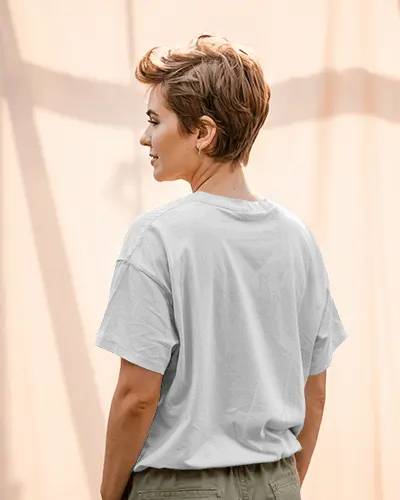Sunlit Back View Tshirt Mockup With Short Haired Female Model In Warm Outdoor Curtain Background