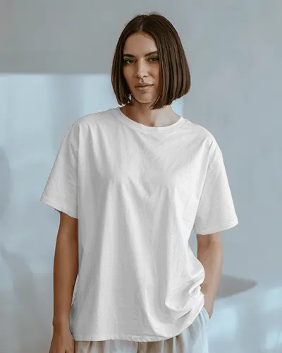Aesthetic Indoor Tshirt Mockup On Woman Standing In Serene Studio With Soft Shadows And Muted Palette