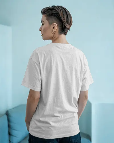 Stylish Back Design Tshirt Mockup Featuring Woman In Minimal Living Space With Light Toned Wall And Couch