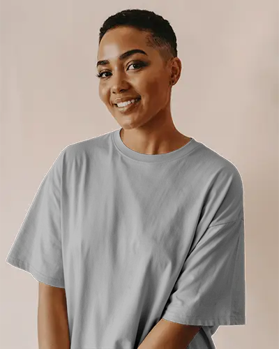 Warm Neutral Background T Shirt Mockup Smiling Female Model With Buzzcut Wearing Grey Tee In Soft Studio Light