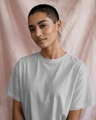 Indoor T Shirt Mockup Female Model With Buzzcut Wearing White Tee Soft Lighting And Pink Fabric Backdrop