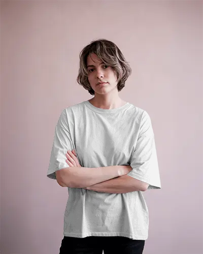 Casual Fashion Tshirt Mockup Featuring Woman In Loose White Tee And Neutral Pink Toned Background