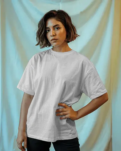 Fashion Forward Tshirt Mockup On Woman In Studio Setting With Soft Curtain Background And Bold Expression