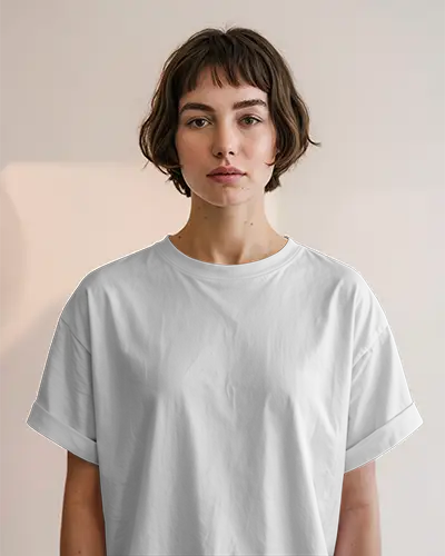 Minimal Studio T Shirt Mockup Female Model With Short Curly Bob In White Tee Facing Forward Against Soft Beige Wall