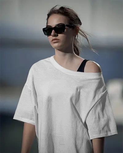 Streetwear Inspired Tshirt Mockup Featuring Model In Relaxed Off Shoulder Tee Under Natural Sunlight