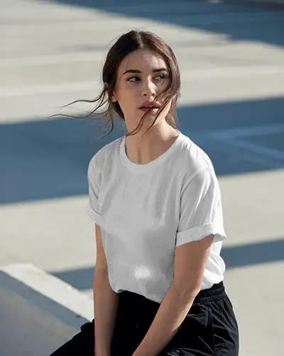 Sunlit Outdoor Tshirt Mockup With Female Model In Rolled Sleeve On Concrete Background