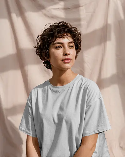 Natural Sunlit T Shirt Mockup Woman With Curly Hair In Soft Light And Neutral Backdrop