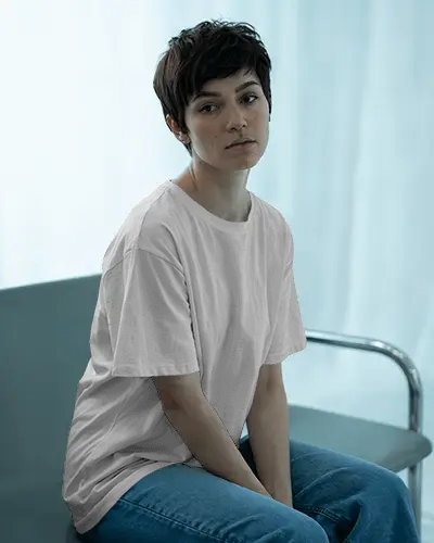 Minimalist Room T Shirt Mockup Female Model In Clean Tee With Cool Toned Curtains