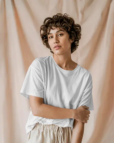 Soft Drape Backdrop T Shirt Mockup Female Model With Curly Hair And Natural Light