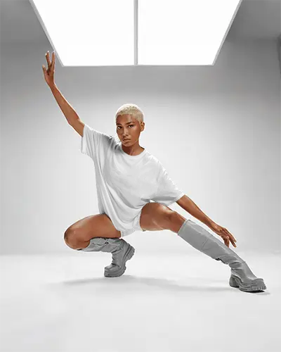 Futuristic Studio T Shirt Mockup Model In Dynamic Dance Pose Under Softbox Light