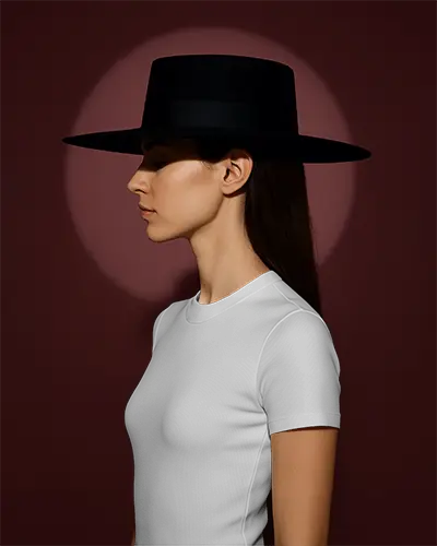 Fitted White Crew Neck Short Sleeve T Shirt Mockup Side Profile Female Model In Black Wide Brim Hat Deep Maroon Background Dramatic Spotlight Minimal And High Fashion Vibe