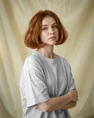 Studio Lit Tshirt Mockup Female Model With Red Bob Hair Arms Crossed Soft Background