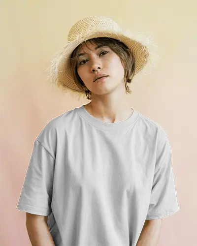 Pastel Gradient Background T Shirt Mockup Female Model Wearing Straw Hat Staring Directly Calm And Minimal Summer Vibes