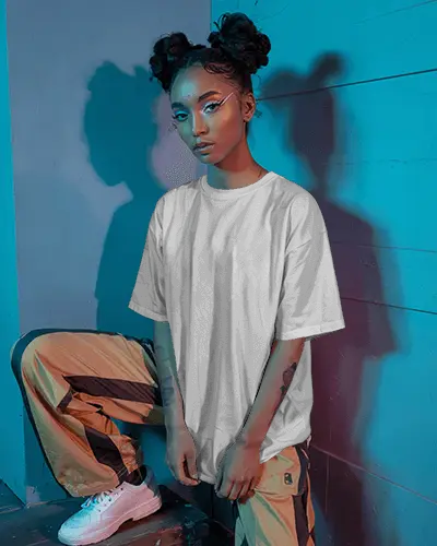 Neon Lit Tshirt Mockup Female Model In Streetwear Pose Under Cyan And Purple Light