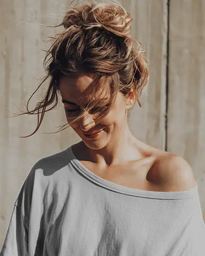 Sunlit Outdoor T Shirt Mockup Female Model In Off Shoulder White Tee Natural Light Soft Smile Casual Minimalist Fashion Style