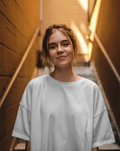 Realistic T Shirt Mockup On Happy Woman In Contemporary Urban Setting Perfect For Streetwear Designs