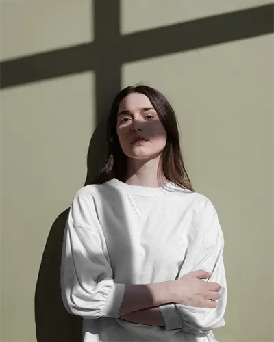 Serene Mood Tshirt Mockup Woman Crossing Arms With Soft Sunlight And Clean Wall Background