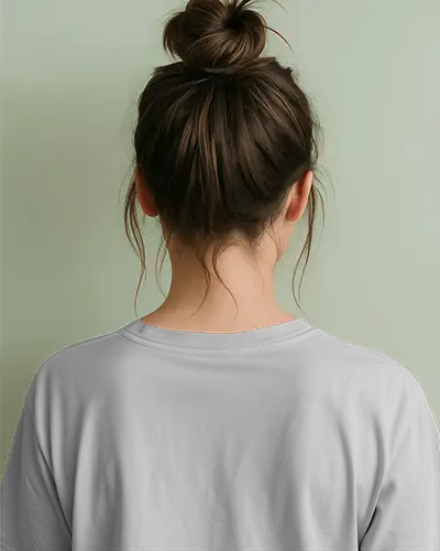 Back View Tshirt Mockup Female Model Messy Bun Soft Sage Background Minimalist Lifestyle Scene