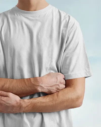 Casual Studio Tshirt Mockup Male Model Crossed Arms On Soft Sky Backdrop
