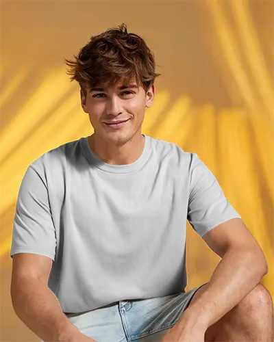 Youthful Energy White Tshirt Mockup Male Model In Casual Summer Look Sitting Against Yellow Curtain Vibrant Light Play Modern Brand Style