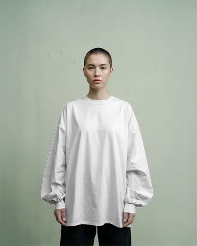 Long Sleeve White Tshirt Mockup Buzzcut Female Model Standing Front Facing In Soft Green Studio Minimalist Brand Template For Fashion