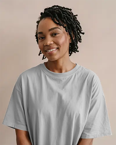 Front View White Tshirt Mockup Smiling Woman With Twisted Hairstyle Soft Pastel Peach Background Natural Lighting Clean Fashion Template