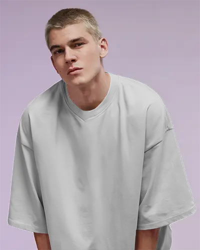 Bold Front Facing Oversized Tee Mockup Male Model In White Shirt Against Purple Studio Background Ideal For Streetwear Or Unisex Designs