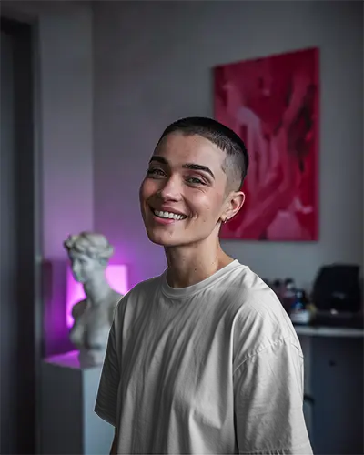 Studio Art Tshirt Mockup Smiling Model In White Tee Soft Lighting And Modern Creative Interior Vibe