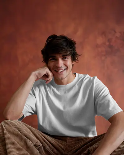 Relaxed Photoshoot Tshirt Mockup Male Model Laughing In White Shirt With Earthy Studio Setting