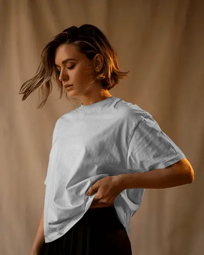 Cinematic Soft Light Tshirt Mockup Woman Holding Tshirt Edge Calm Expression