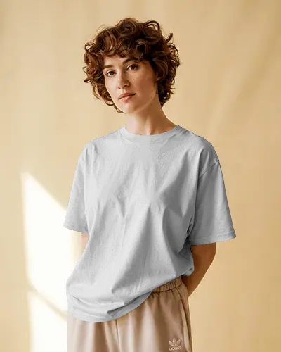 Cozy Natural Light Tshirt Mockup Curly Haired Woman In Loose Tee Casual Pose