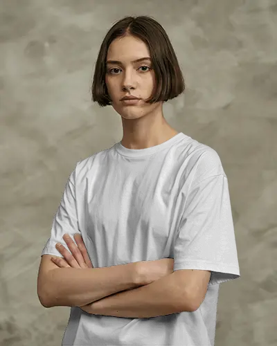 Neutral Studio T Shirt Mockup Female Model Crossed Arms Minimal Expression Clean Background