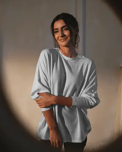 Spotlight Tshirt Mockup Smiling Female Model In Relaxed Pose Evening Ambience