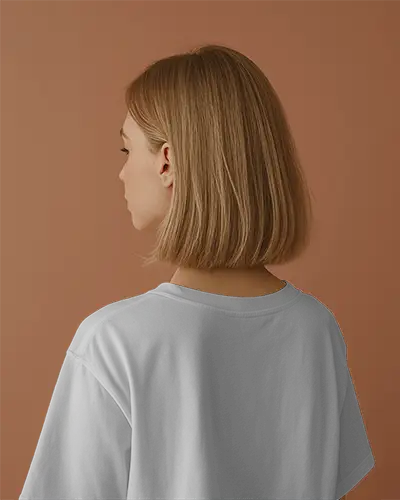 Relaxed Back Angle T Shirt Mockup Female Model With Blunt Bob Styled In Dark Minimal Shirt Natural Light