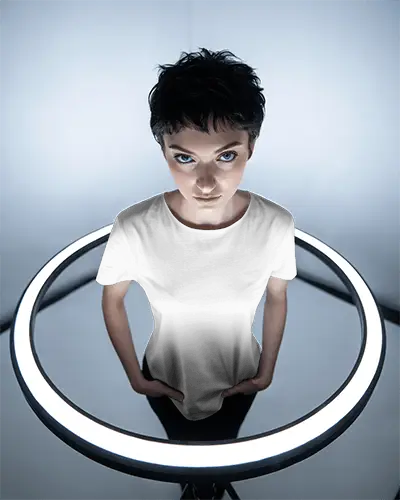 Futuristic Studio T Shirt Mockup Female Model Under Glow Ring Light Top View Intense Expression Modern Editing