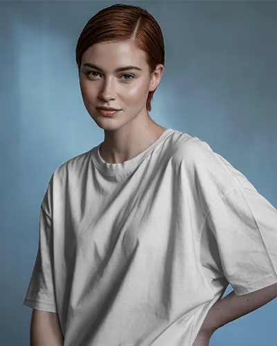 Editorial Style Tshirt Mockup Female Model In Loose Fit Oversized Tee Soft Blue Studio Background Clean And Confident Look