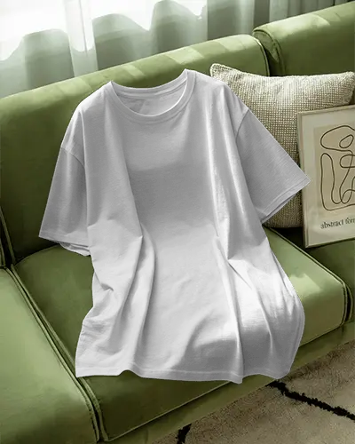 Casual Cozy Tshirt Mockup Loose Fit Tee Draped On Green Couch With Sunlight Abstract Art Decor Home Interior Vibe