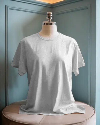 Boutique Style Interior T Shirt Mockup Featuring Dress Form On Round Pouf Under Soft Natural Lighting