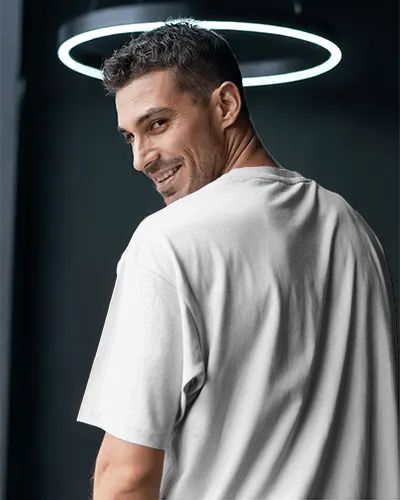 Stylish Back Print T Shirt Mockup With Man In Turned Pose Beneath Contemporary Lighting For Urban Fashion Branding