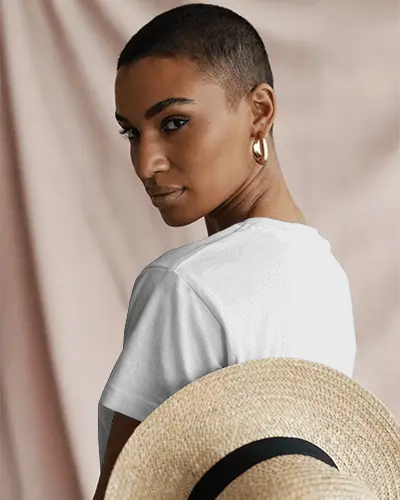 Confident Female Model T Shirt Mockup With Back Print Design Holding Summer Hat Against Neutral Fabric Backdrop