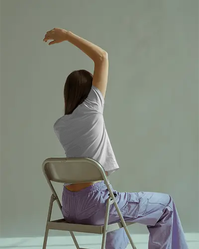 Seated Urban Style Tshirt Mockup With Back Facing Model In Casual Pose Showing Back Design On Modern Fit