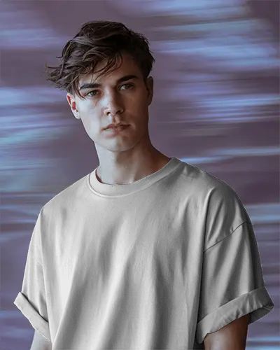 Soft Texture Tshirt Mockup Male Model In Rolled Sleeve Tee Facing Camera With Dreamy Purple Backdrop