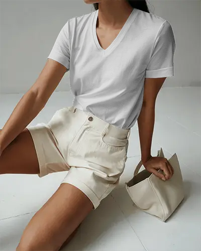 Minimalistic Interior Tshirt Mockup Female Model Seated In Light Filled Room Wearing V Neck Tee And Shorts