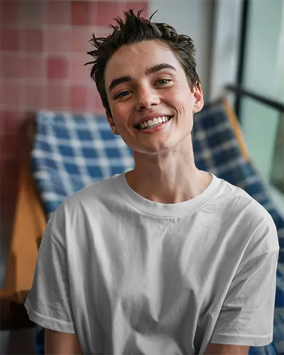 Sunny Window Seating T Shirt Mockup Smiling Model Sitting On Wooden Chair Relaxed And Warm Atmosphere Casual Interior