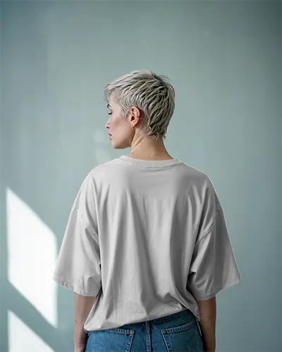 Sunlit Blue Wall T Shirt Mockup Female Model With Platinum Blonde Pixie Cut In Natural Light Casual Minimal Aesthetic