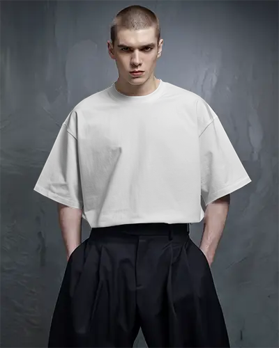 Moody Studio T Shirt Mockup Male Model With Buzzcut In High Fashion Pose Against Textured Dark Grey Background